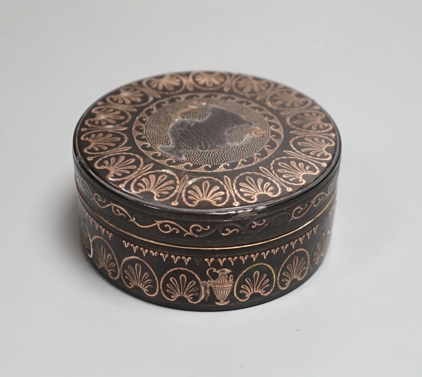 A 19th century yellow metal inlaid circular box and cover 8cm diameter